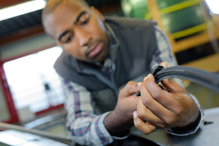 Man holding length of rubber