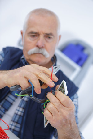 renovation light switch and plug socket on wall handの写真素材