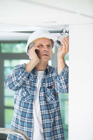 electrical engineer make phone call to control centerの写真素材