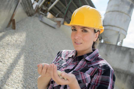 construction factory with female engineer checking gravelの写真素材