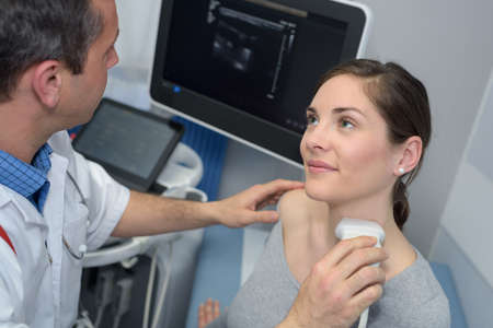 doctor visiting patient in hospital for examinationの写真素材