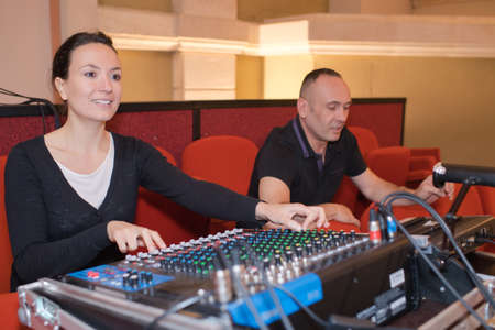 sound engineer and producer working together at mixing panelの写真素材