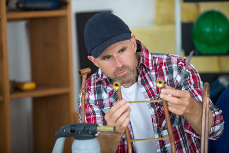 plumber is about to weld metal pipesの写真素材