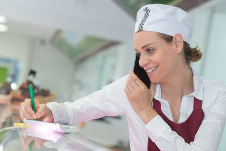 smiling female doctor at the clinic reception deskの写真素材
