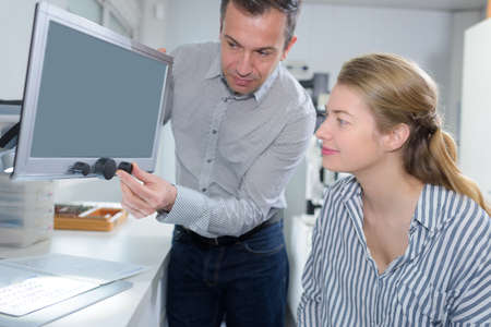 man showing woman screen mechanismの写真素材