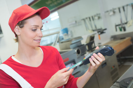 Lady in fast food outlet taking card payment