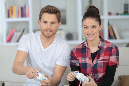 happy young couple playing video games