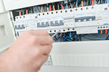 Electrician repairing a fuseの写真素材