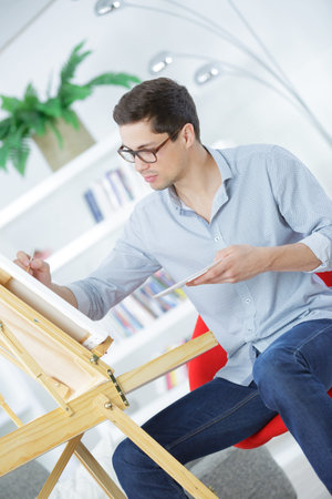 portrait of a young male artist at work