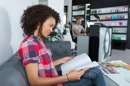 happy woman waiting for a treatment at a beauty salonの写真素材