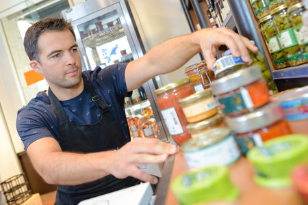 portrait of strapping young seller at shopの写真素材