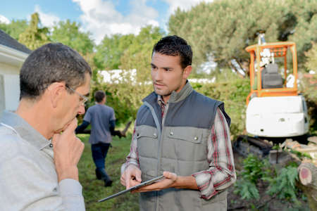 Foreman explaining something to a colleagueの写真素材