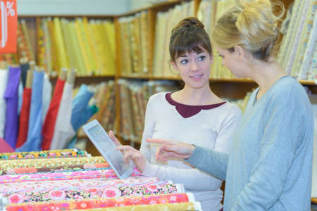 designer choosing fabric at haberdasheryの写真素材