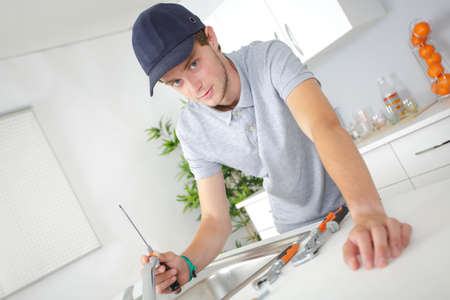 fixing a tapの写真素材