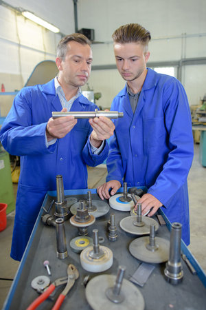 Engineers assessing parts in workshop