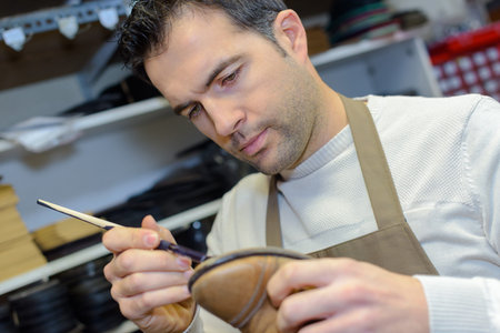 Cobbler repairing shoe