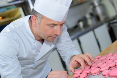 Chef making macaroonsの写真素材