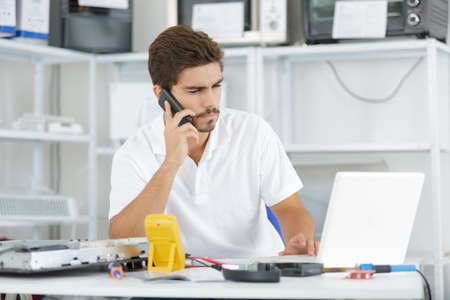 technician reqesting some help from the hqの写真素材