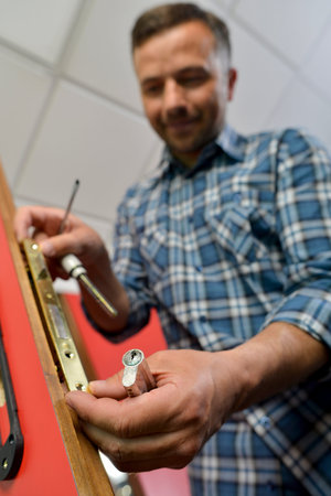 Man fitting a new door lock