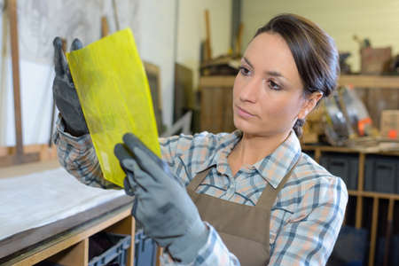 Artist holding yellow materialの写真素材