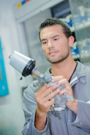 Mechanic holding spare partの写真素材