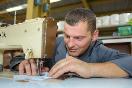 man on sewing machineの写真素材