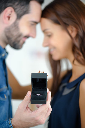 young man is asking beautiful girl for her hand