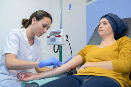 patient getting blood taken by nurse in hospital