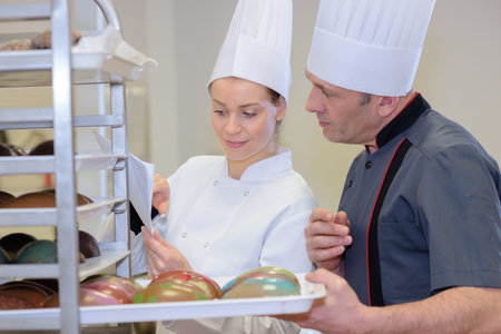 team of bakers in the kitchen of the bakeryの写真素材