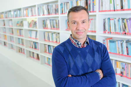 Portrait of man in libraryの写真素材