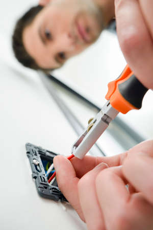 Man cutting wires in a plugの写真素材