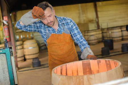 Cooper wiping sweat from foreheadの写真素材