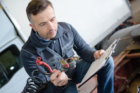 portrait of male mechanic at work in the garage