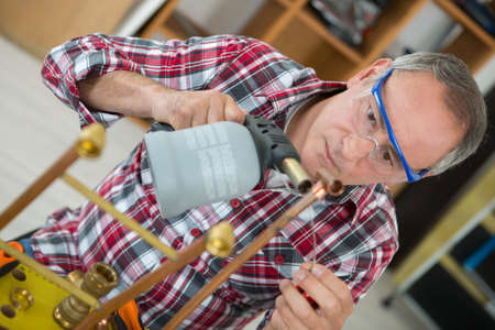 worker using a blowtorchの写真素材
