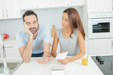 Depressed couple looking at note