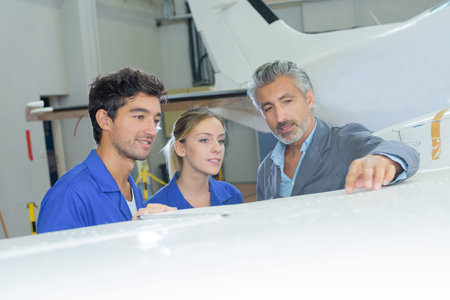 Students looking at wing of aircraft