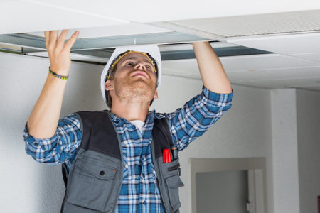 electrical worker wiring in ceilingの写真素材