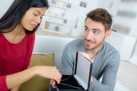 Offering a gift to his girlfriendの写真素材