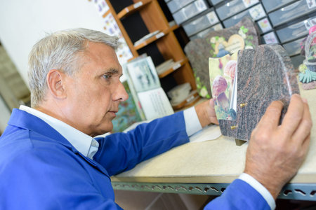Man making marble plaque