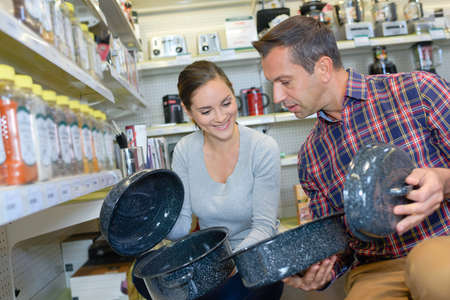 Couple looking at enamel cooking dishesの写真素材