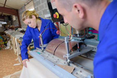 Man and woman using industrial machine