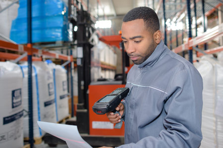 Warehouse worker using handheld scannerの写真素材