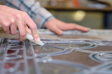 Female artist working with glassの写真素材