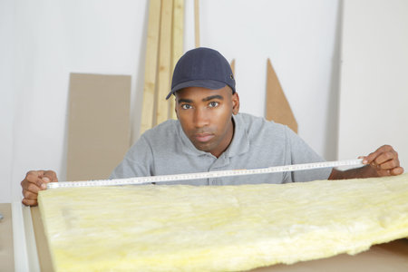Workman measuring insulation