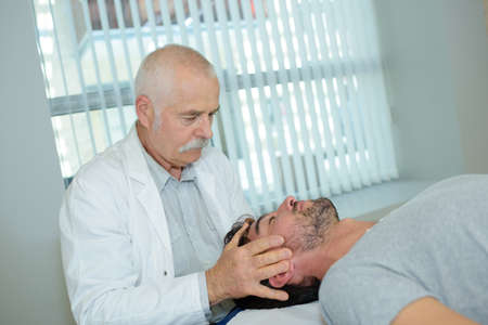 Doctor massaging patient's headの写真素材