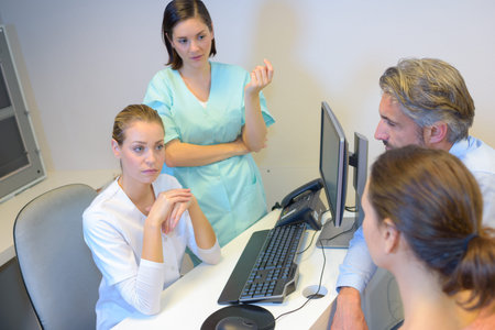 Medics in consultation with middle aged couple