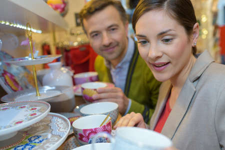 couple looking at items displayed in shopping in mallの写真素材
