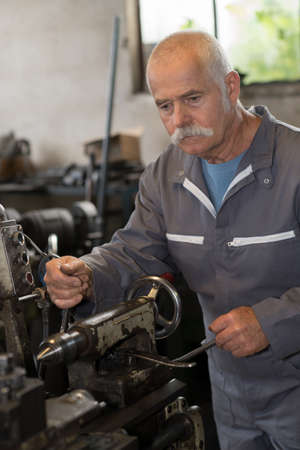 Senior metalworker in workshopの写真素材