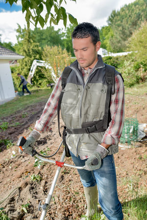 Gardener using a strimmer