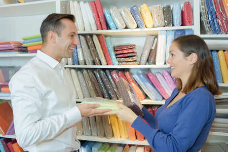 couple choosing bed sheets in a household storeの写真素材